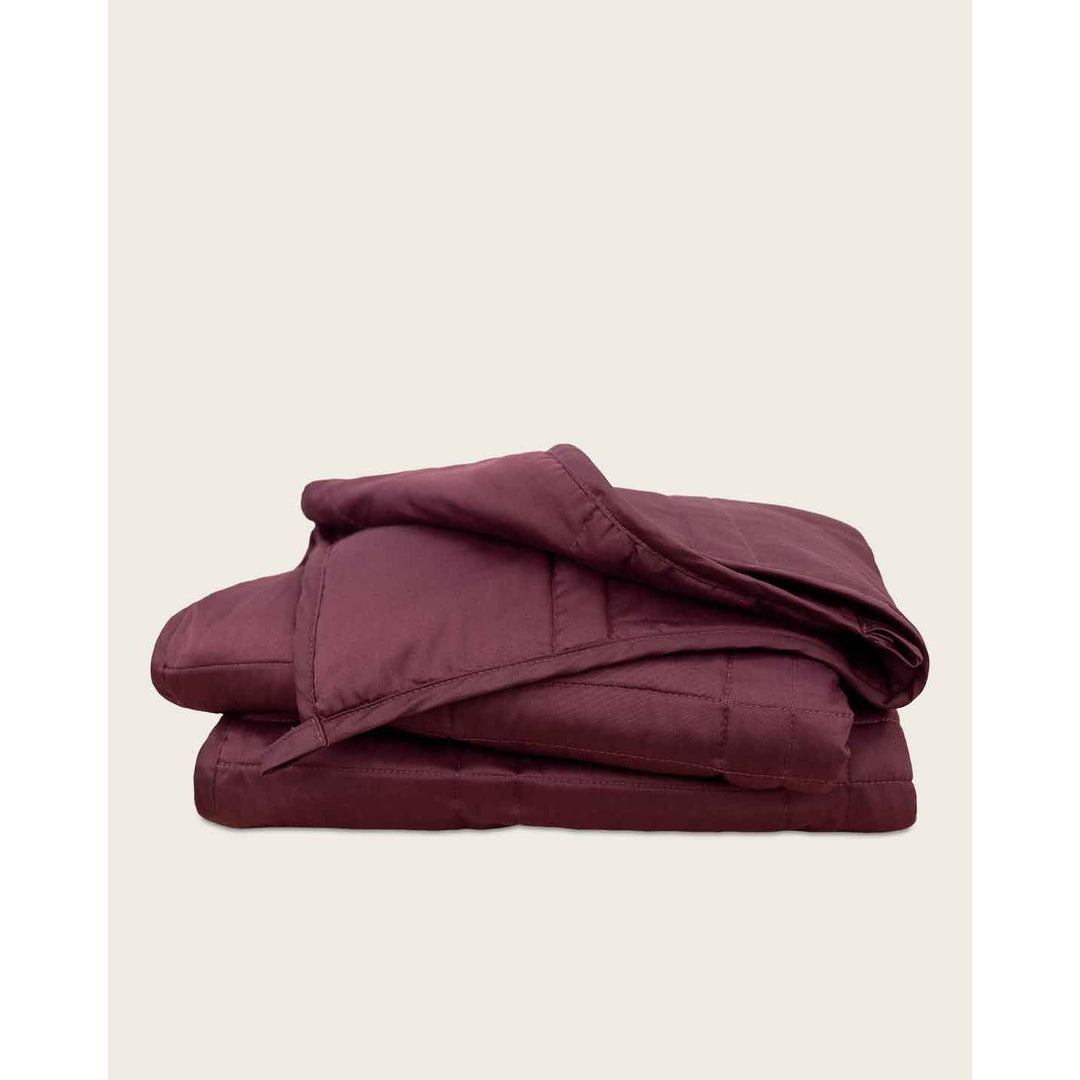 A folded blanket against a plain background [44405994029275,45574417907931]