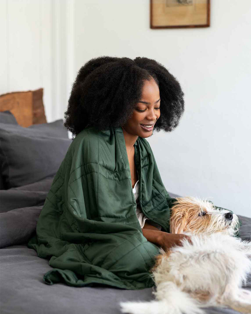 A woman sits in bed petting a dog [46061921730779, 46301205299419, 46061921763547, 46301205332187, 46061921796315, 46301205364955, 46063267709147, 46301205266651, 46063269118171, 46730787389659, 46730787422427,46730787455195, 46730787487963]
