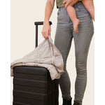 Load image into Gallery viewer, A woman stands next to a suitcase holding a silver sage lap blanket in one hand, and a baby in the other. [43580656746715, 46288037413083]
