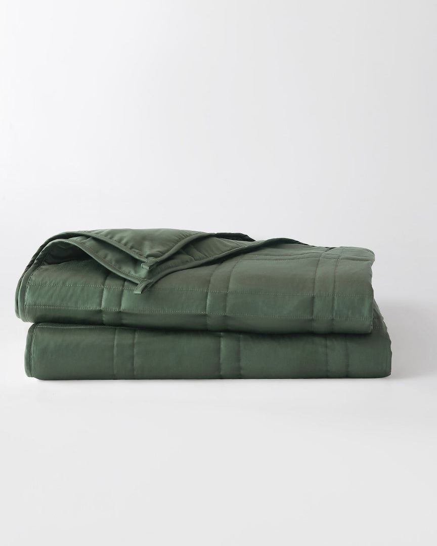 folded weighted blanket in spruce green against an empty background [44422820561115, 44422814826715, 44422813090011, 44422818234587,46061921730779, 46301205299419, 46061921763547, 46301205332187, 46061921796315, 46301205364955, 46063267709147, 46301205266651, 46063269118171, 46730787389659, 46730787422427,46730787455195, 46730787487963]