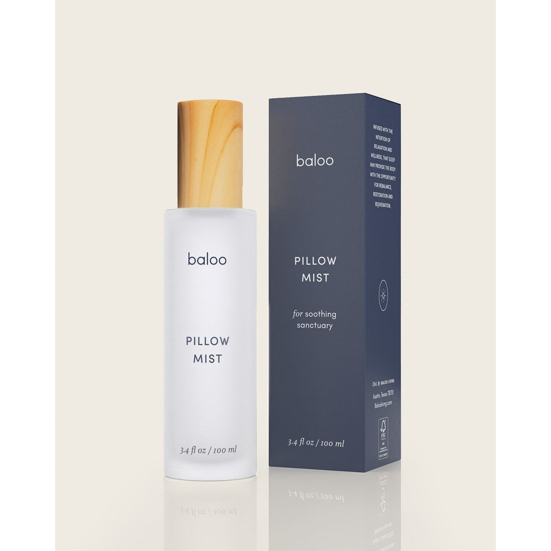 Bottle of Baloo Pillow mist in a frosted glass next to the blue product box. 