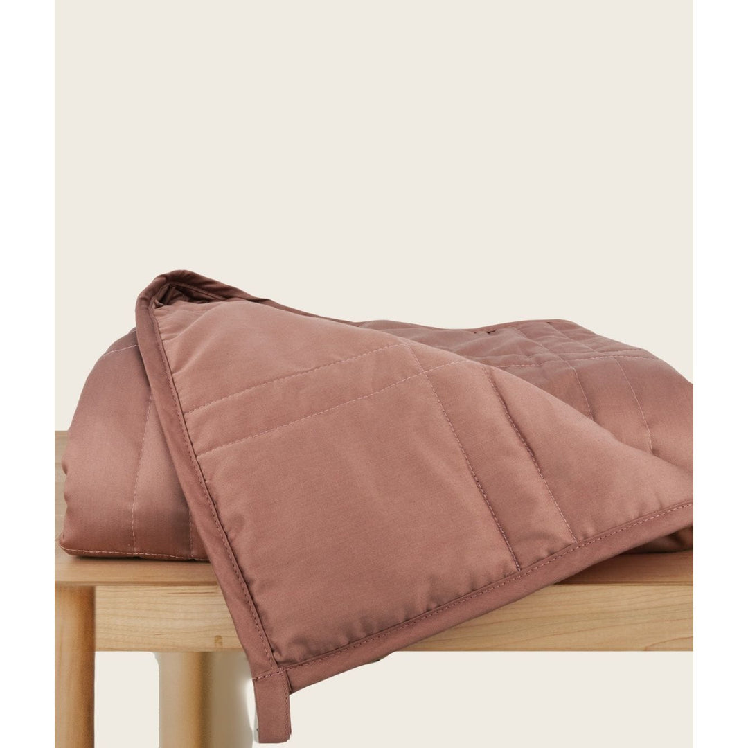 [44676999741659] Hope Rose weighted blanket folded on a table