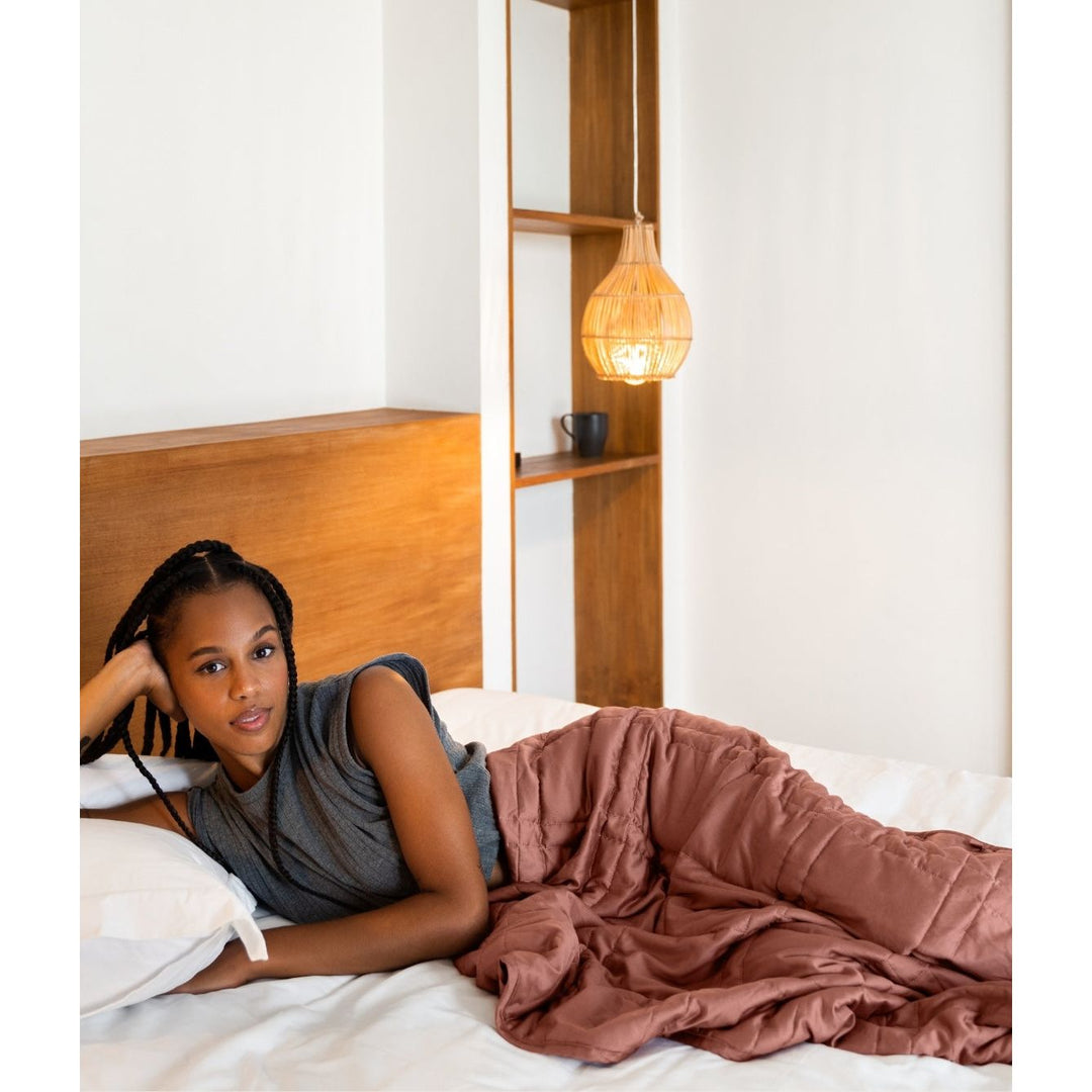 [44676999741659] a woman in bed faces the camera 