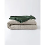 Load image into Gallery viewer, A silver sage weighted throw with a spruce green cotton duvet cover folded on top. [460619214030-9, 4630120510281-1]
