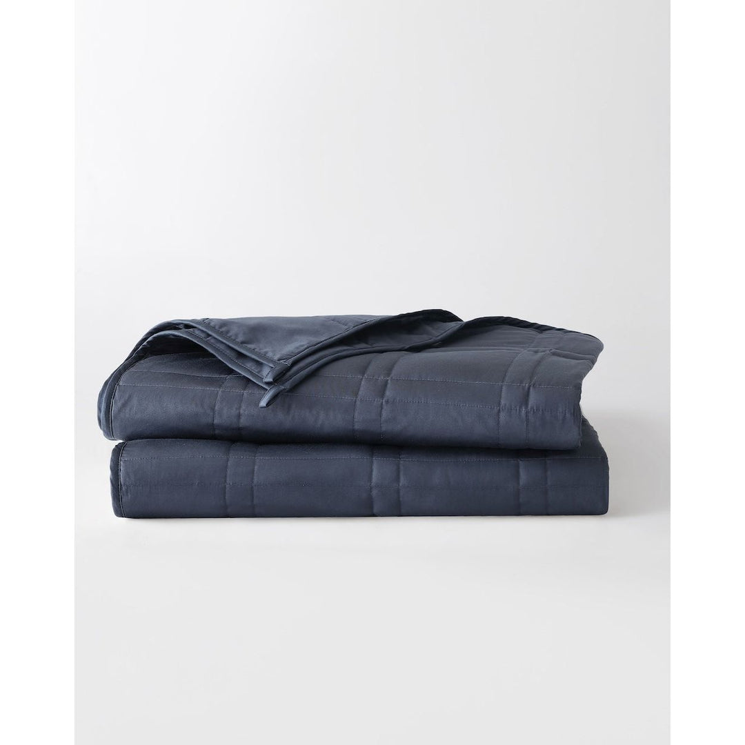 folded weighted blanket in luna blue against an empty background [43649942782171, 44422804340955, 44422811287771, 44422816432347, 46061921468635, 46301205168347, 46061921501403, 46301205201115, 46061921534171, 46301205233883, 46063267643611, 46301205135579, 46063269052635]