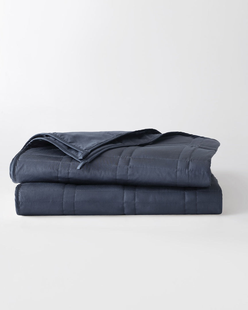 folded weighted blanket in luna blue against an empty background [43649942782171, 44422804340955, 44422811287771, 44422816432347, 46061921468635, 46301205168347, 46061921501403, 46301205201115, 46061921534171, 46301205233883, 46063267643611, 46301205135579, 46063269052635, 46730787127515, 46730787160283,46730787193051, 46730787225819]