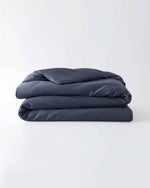 Load image into Gallery viewer, A folded cotton duvet cover in Luna Blue on a blank background [44422682083547, 45027100033243,46061921763547, 46063268331739, 46061921632475, 46061921501403, 46061921370331, 46730800693467, 46730800824539, 46730800955611, 46730801086683]
