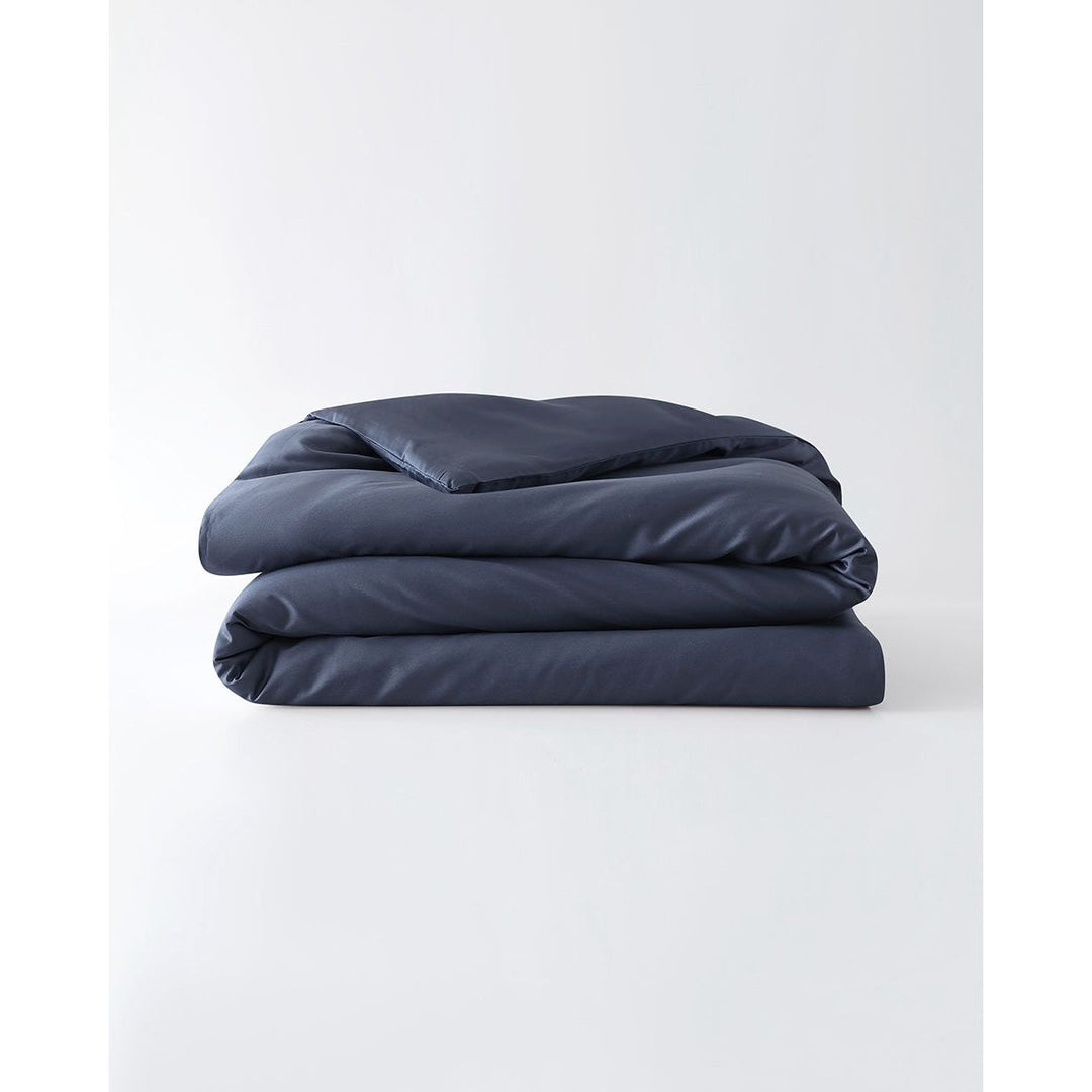 A folded cotton duvet cover in Luna Blue on a blank background [44422682083547, 45027100033243,46061921763547, 46301205332187, 46063268331739, 46301204938971, 46061921632475, 46061921501403, 46301205201115, 46061921370331, 46301205070043]