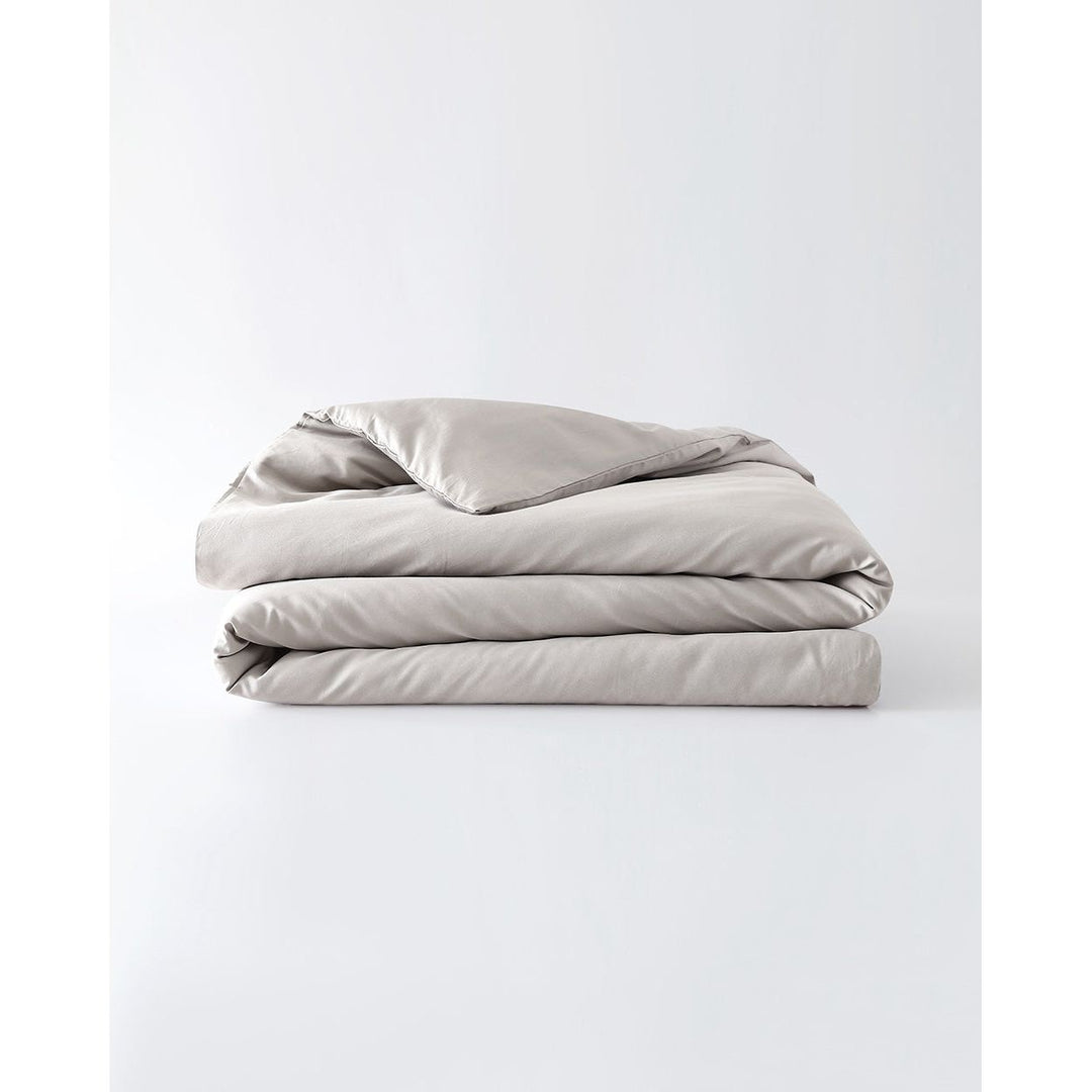 A silver sage cotton duvet cover folded against an empty background [44422682050779, 45027099771099,46061921337563, 46301205037275,46061921468635, 46301205168347,46061921599707,46061921730779, 46301205299419,46063268298971, 46301204906203]