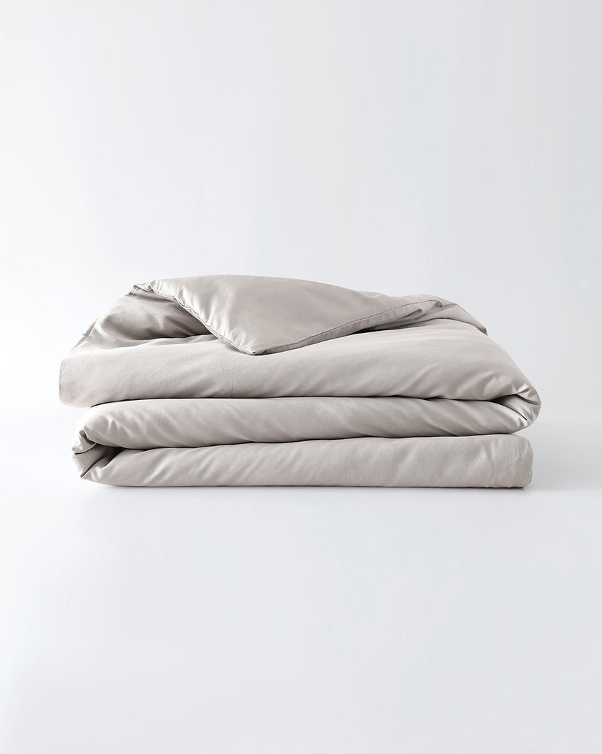 A silver sage cotton duvet cover folded against an empty background [44422682050779, 45027099771099, 46061921337563, 46301205037275, 46061921468635, 46301205168347, 46061921599707, 46061921730779, 46301205299419, 46063268298971, 46301204906203, 46730786635995, 46730786898139, 46730787160283, 46730787422427]
