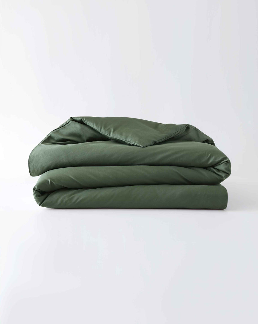 A folded cotton duvet cover in spruce against a plain background [44422682116315,46063268364507, 46061921796315, 46061921665243, 46061921534171, 46061921403099,46730800726235, 46730800857307, 46730800988379, 46730801119451]