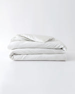 Load image into Gallery viewer, A white cotton duvet cover folded against an empty background [44422681886939, 45027099410651, 46063267610843, 46301205004507, 46063267643611, 46301205135579, 46063267676379, 46063267709147, 46301205266651, 46063268397275, 46301204873435, 46730786603227, 46730786865371, 46730787127515, 46730787389659]
