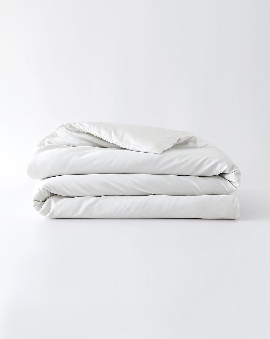 A white cotton duvet cover folded against an empty background [44422681886939, 45027099410651, 46063267610843, 46301205004507, 46063267643611, 46301205135579, 46063267676379, 46063267709147, 46301205266651, 46063268397275, 46301204873435, 46730786603227, 46730786865371, 46730787127515, 46730787389659]