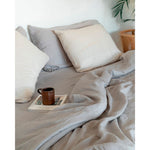 Load image into Gallery viewer, A bed with a dove grey duvet cover in linen, a magazine and a mug. [32783545598032, 32783545204816, 32783545401424, 32854363471952, 32854405513296]
