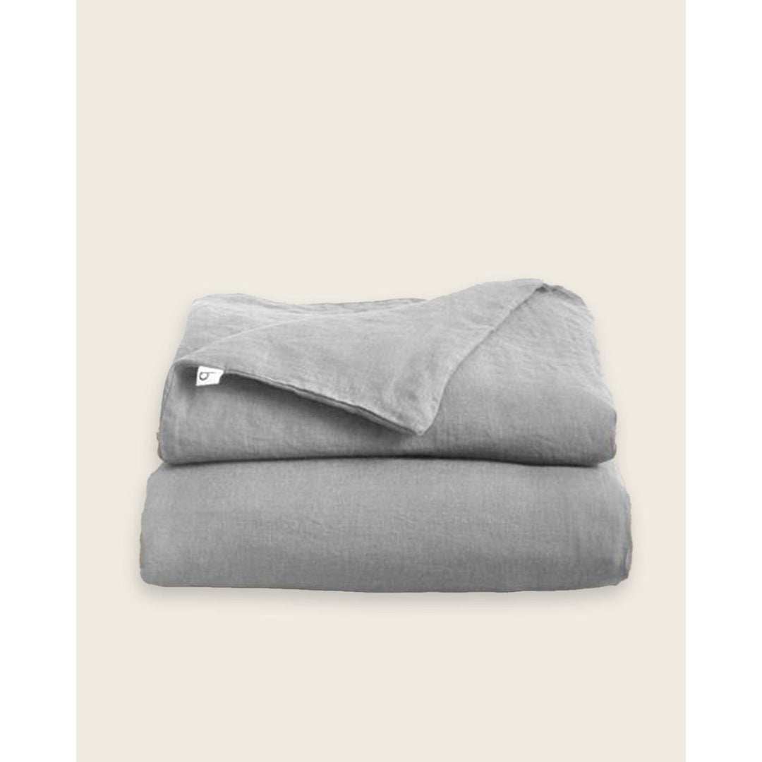 A folded linen duvet in dove grey [32783545598032, 32783545204816, 32783545401424, 32854363471952, 32854405513296]