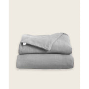 A folded linen duvet in dove grey [32783545598032, 32783545204816, 32783545401424, 32854363471952, 32854405513296]