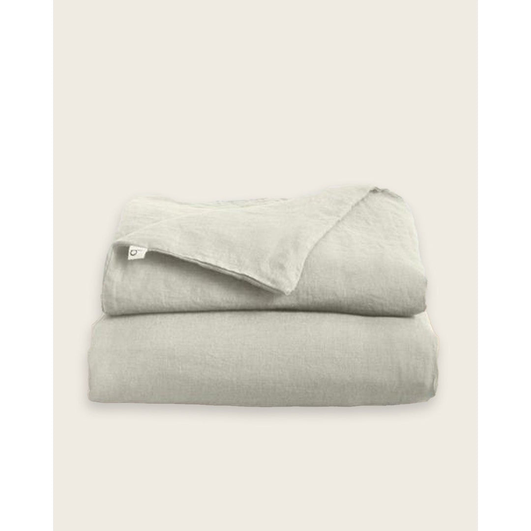 A folded linen duvet cover in oatmeal [32783545729104, 32783545335888, 32783545532496, 32854359507024, 32854401843280]