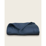 Load image into Gallery viewer, A blue cotton weighted blanket folded up on a plain background. [44385233109211,46089486074075]
