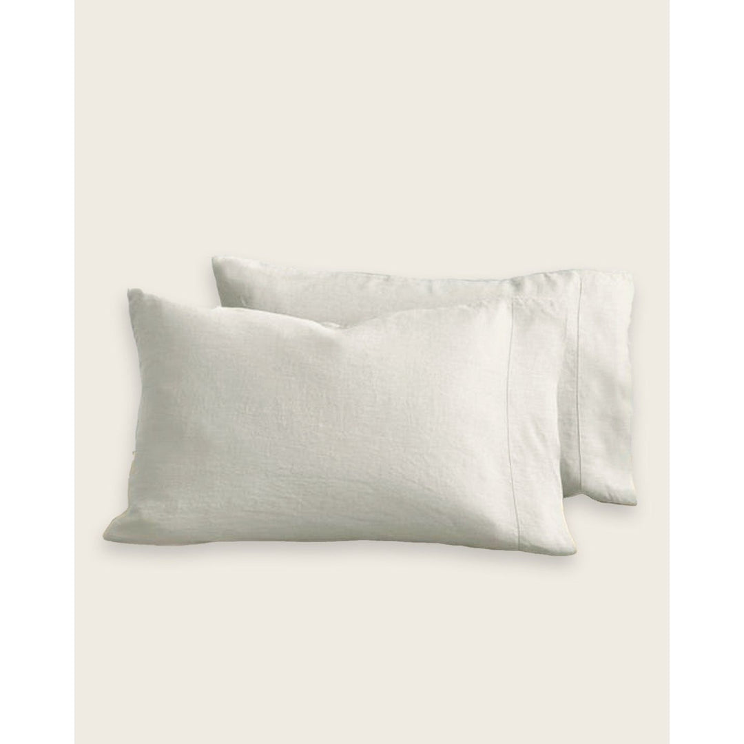 A pair of two pillows leaning up against a blank background. [32783549071440, 32783549268048]