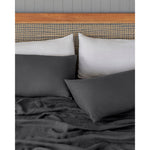 Load image into Gallery viewer, A bed made with linen sheets and four pillows. [32783549202512, 40088400724152]
