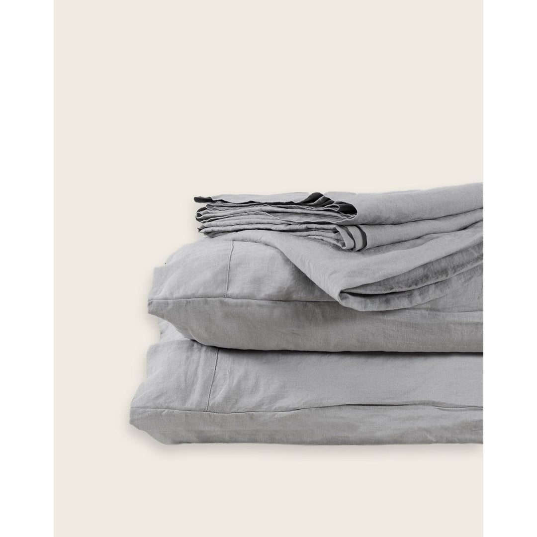 A stack of Dove Grey linens against an empty background [39418737623224, 39418737655992, 39418737688760, 45933256966363]