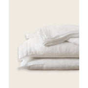 A stack of white linen sheets against a plain background. [39418737524920, 39418737557688, 39418737590456, 45933184057563]