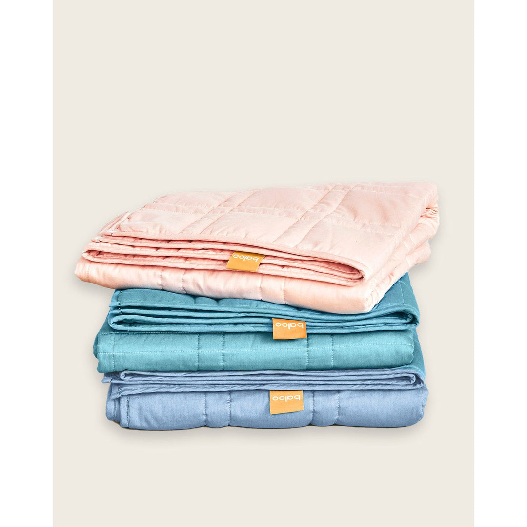 A stack of three folded weighted blankets in bright colors [44385363656923, 44385363722459, 44385363689691]