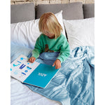 Load image into Gallery viewer, A child reads in bed with an indigo weighed blanket [44385363722459]
