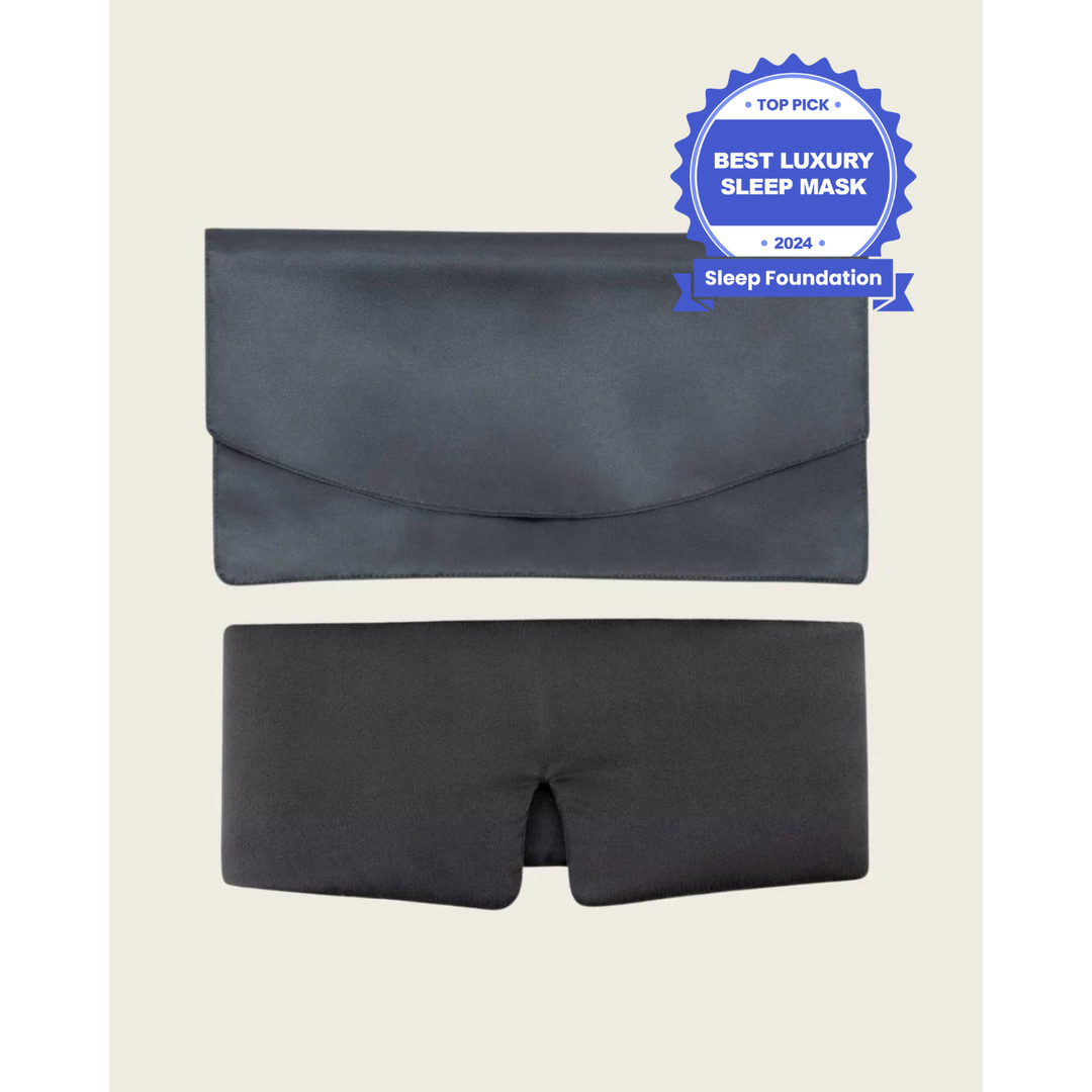 Grey silk sleep mask flatlay next to the pouch. [44377020793051]