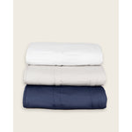 Load image into Gallery viewer, A stack of folded weighted blankets in the colors pebble white, silver sage, and luna blue. [42934587621595, 43649942782171, 42934587818203, 42934587883739, 43690188472539, 42934587850971, 44422804340955, 44422811287771, 44422816432347, 45574417809627,45574417940699,45574418071771, 45574418006235, 45574417842395, 45574417973467,45574418039003, 45574418104539, 45574417875163, 45574418170075, 45574418137307, 45574418268379]
