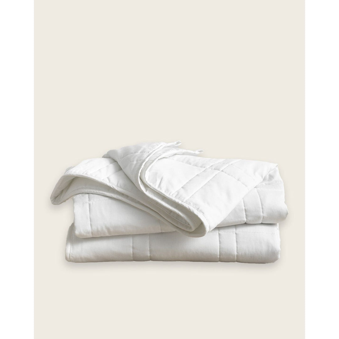 A white cotton weighted blanket is folded on a plain background. [44385233043675, 44385233141979, 44385233207515]