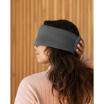 Load image into Gallery viewer, A photo from the side of a woman with long brown hair holding her hand over the back of a silk sleep mask. [44377020793051]
