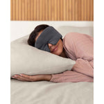 Load image into Gallery viewer, A woman with brown hair asleep on a pillow wearing a grey silk sleep mask [44377020793051]
