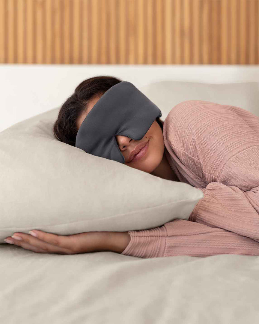 A woman with brown hair asleep on a pillow wearing a grey silk sleep mask [44377020793051,46730820911323, 46730820976859, 46730821042395, 46730821107931]