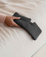 Load image into Gallery viewer, A woman&#39;s hand holds a grey silk sleep mask over the side edge of a bed [44377020793051,46730820911323, 46730820976859, 46730821042395, 46730821107931]
