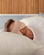 Load image into Gallery viewer, A senior woman with blonde hair rests her head on a pillow wearing a silk sleep mask [44377020825819,46730820944091, 46730821009627, 46730821075163, 46730821140699]
