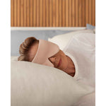 Load image into Gallery viewer, A senior woman with blonde hair rests her head on a pillow wearing a silk sleep mask [44377020825819]
