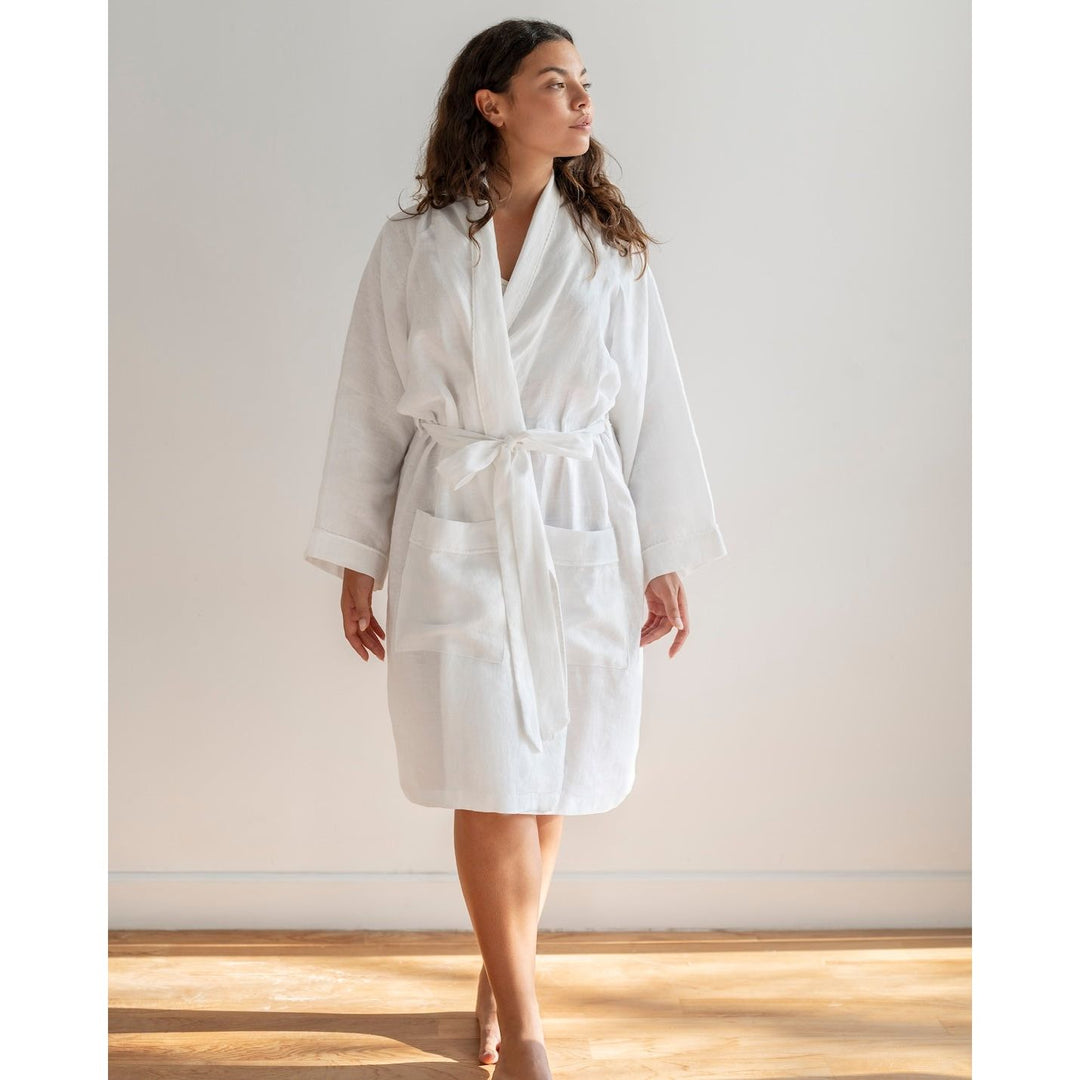Woman looking afar with brown hair wearing white robe [45949468049627, 45949488038107]
