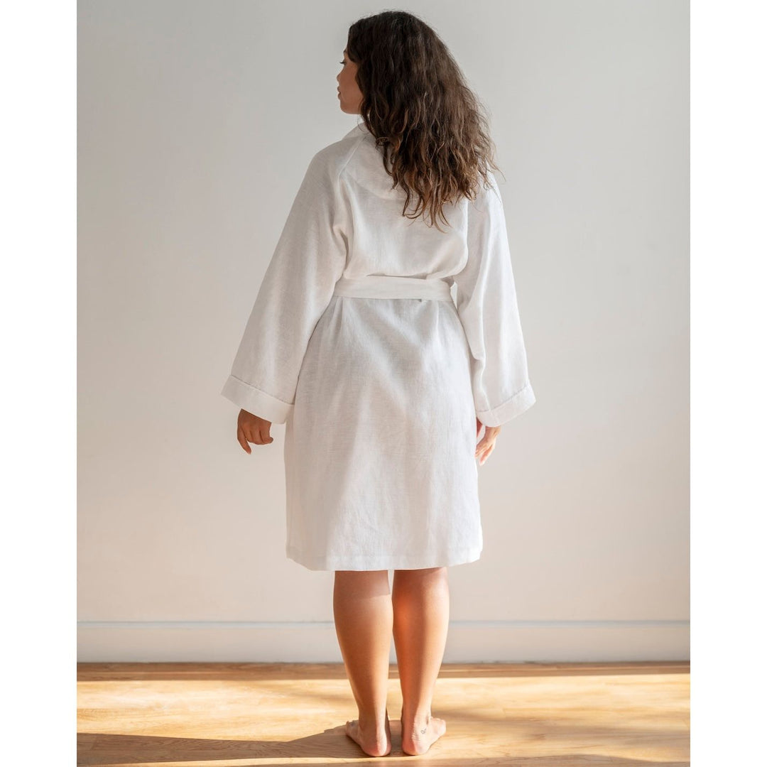 Woman standing in a robe with brown hair wearing a white robe [45949468049627, 45949488038107]