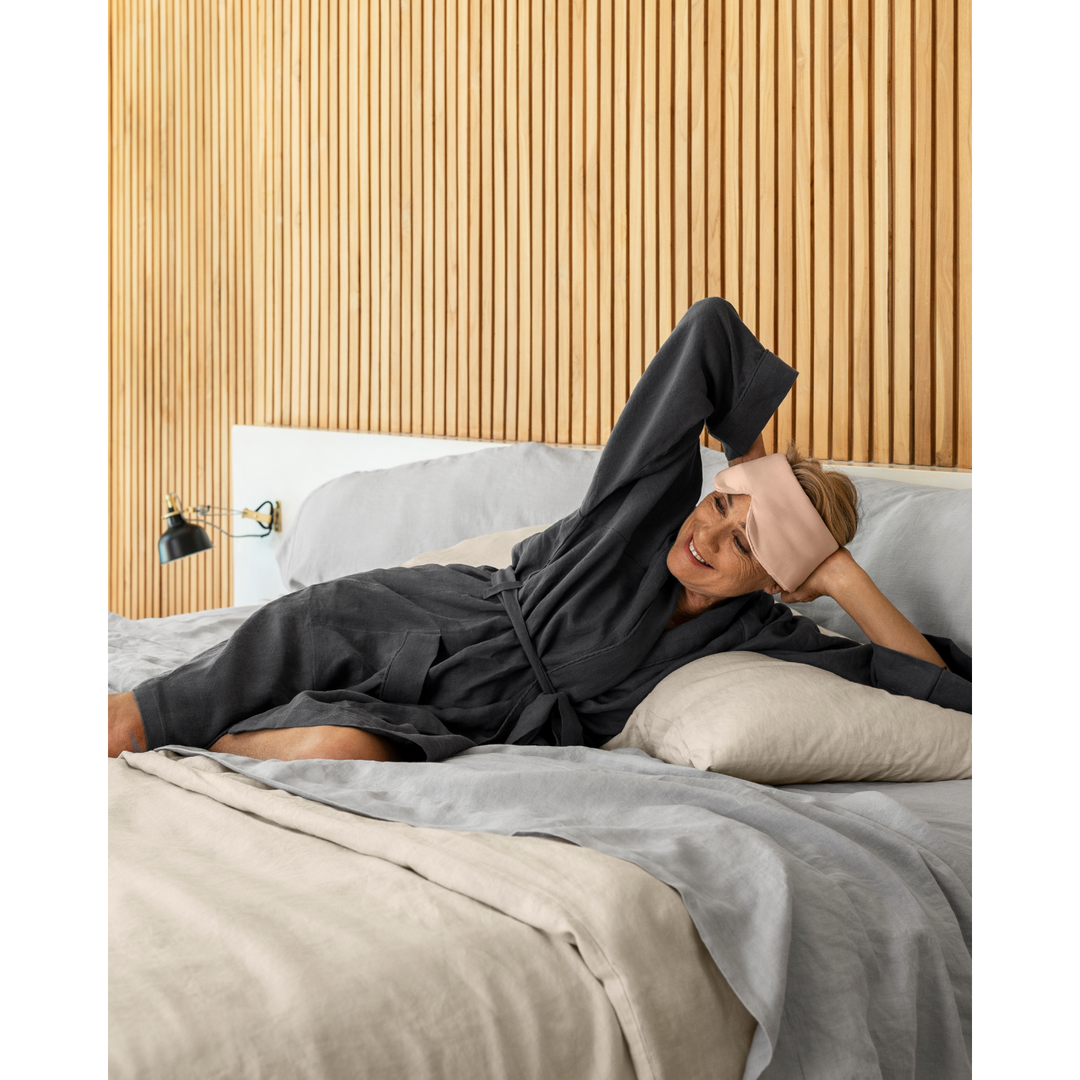 Woman lying in charcoal linen robe [45949489316059, 45949489348827]