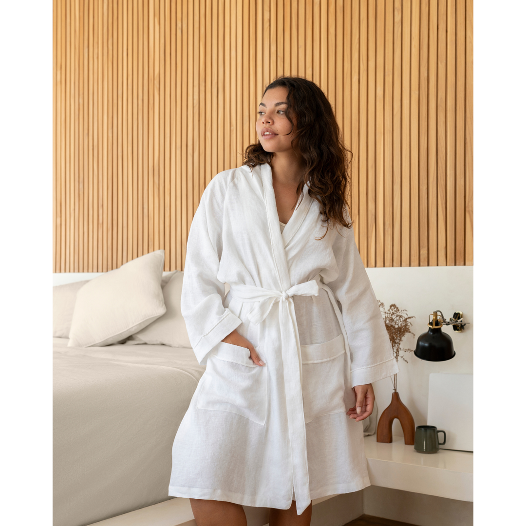 Woman wearing white linen robe with hand in pocket [45949468049627, 45949488038107]